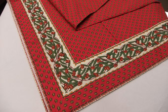 red tablecloth with olive border