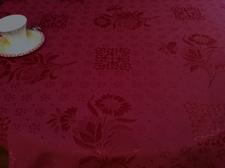 light pique woven French tablecloth in cherry red tones
